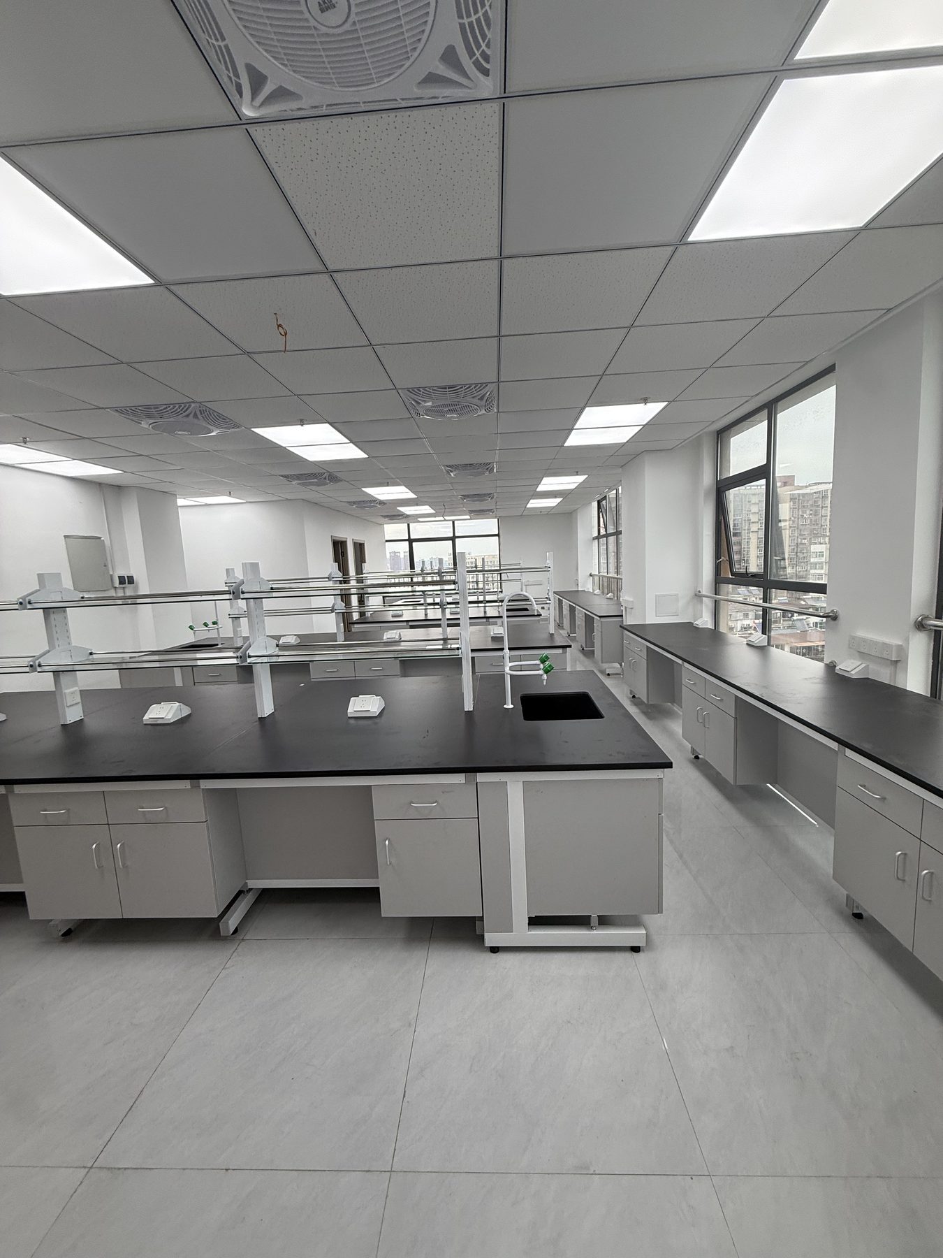 Completed room with grey double-sided island benches and perimeter work surfaces
