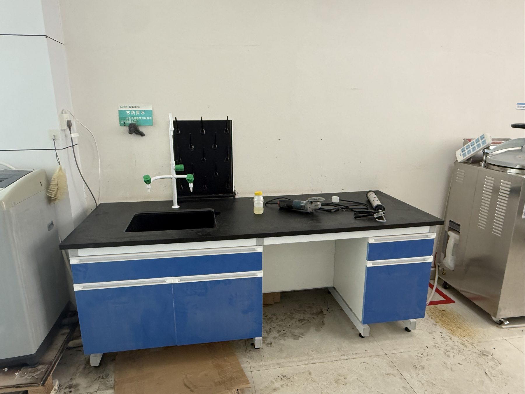 Compact wet laboratory workstation with drawers, cupboard, sink, and open equipment bay