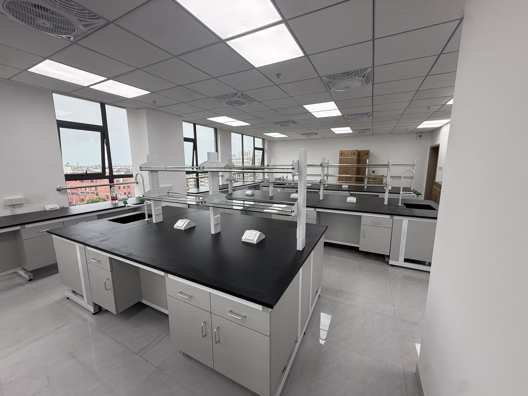 Completed laboratory room showing island benches, wall benches, services, and circulation for site-survey planning