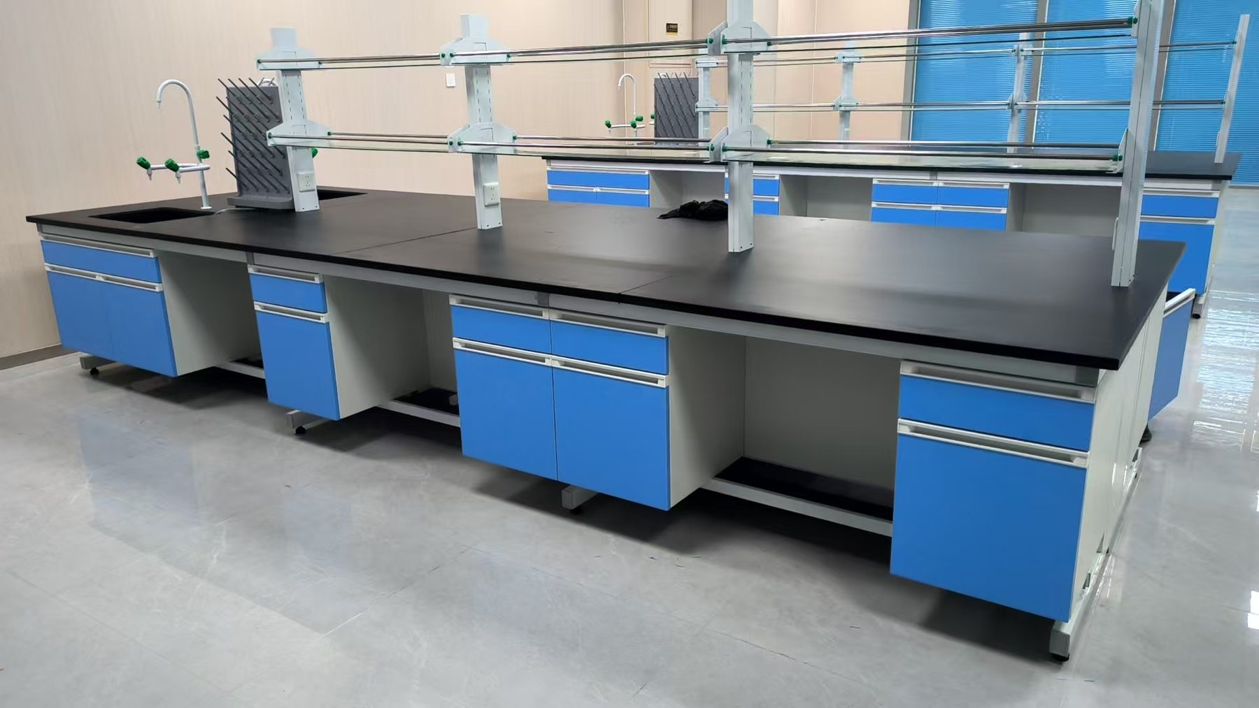 Blue chemistry island bench with black worktop